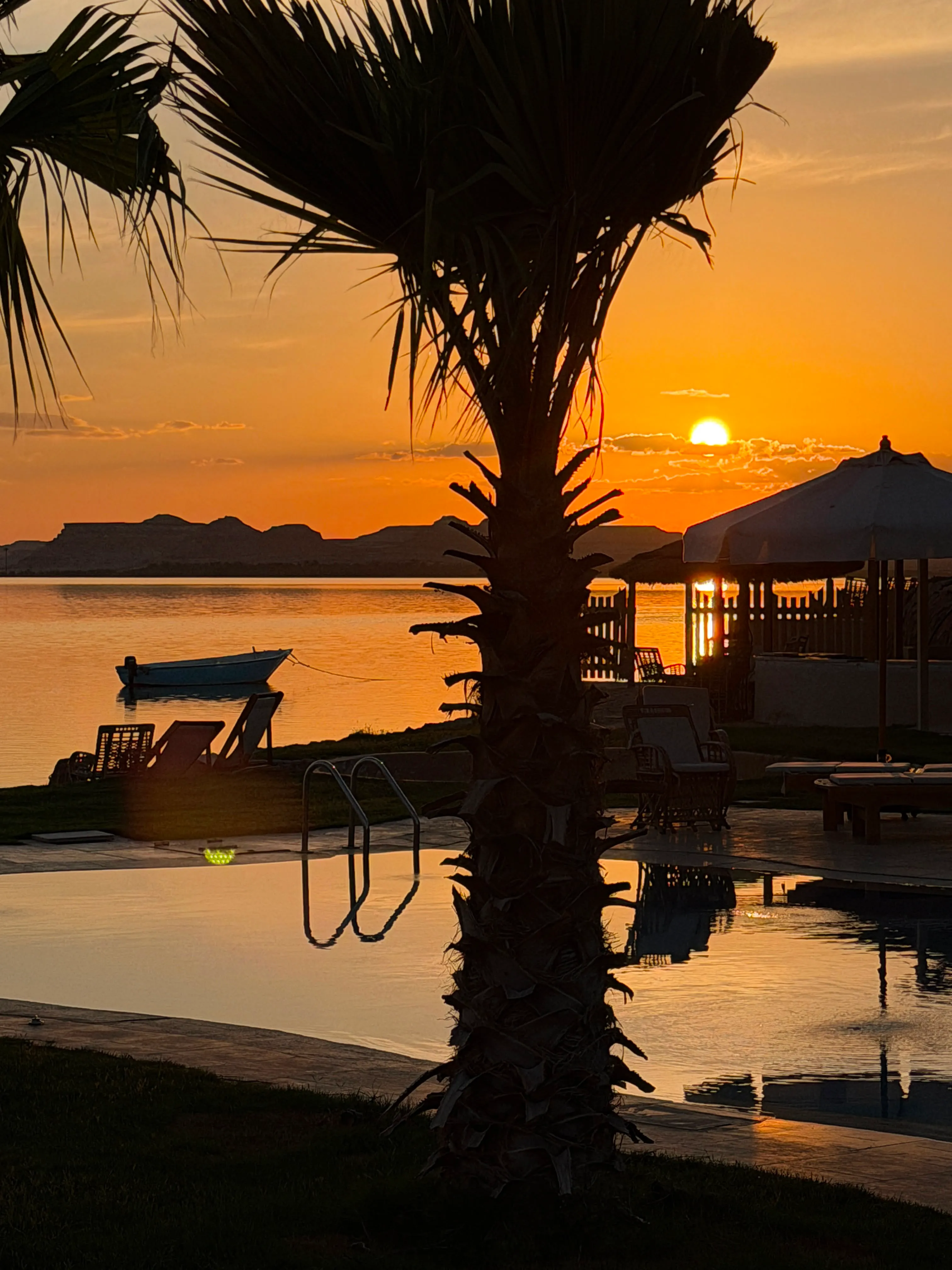 Warm luxury interior at Breezy Island Siwa Oasis retreat with desert view window